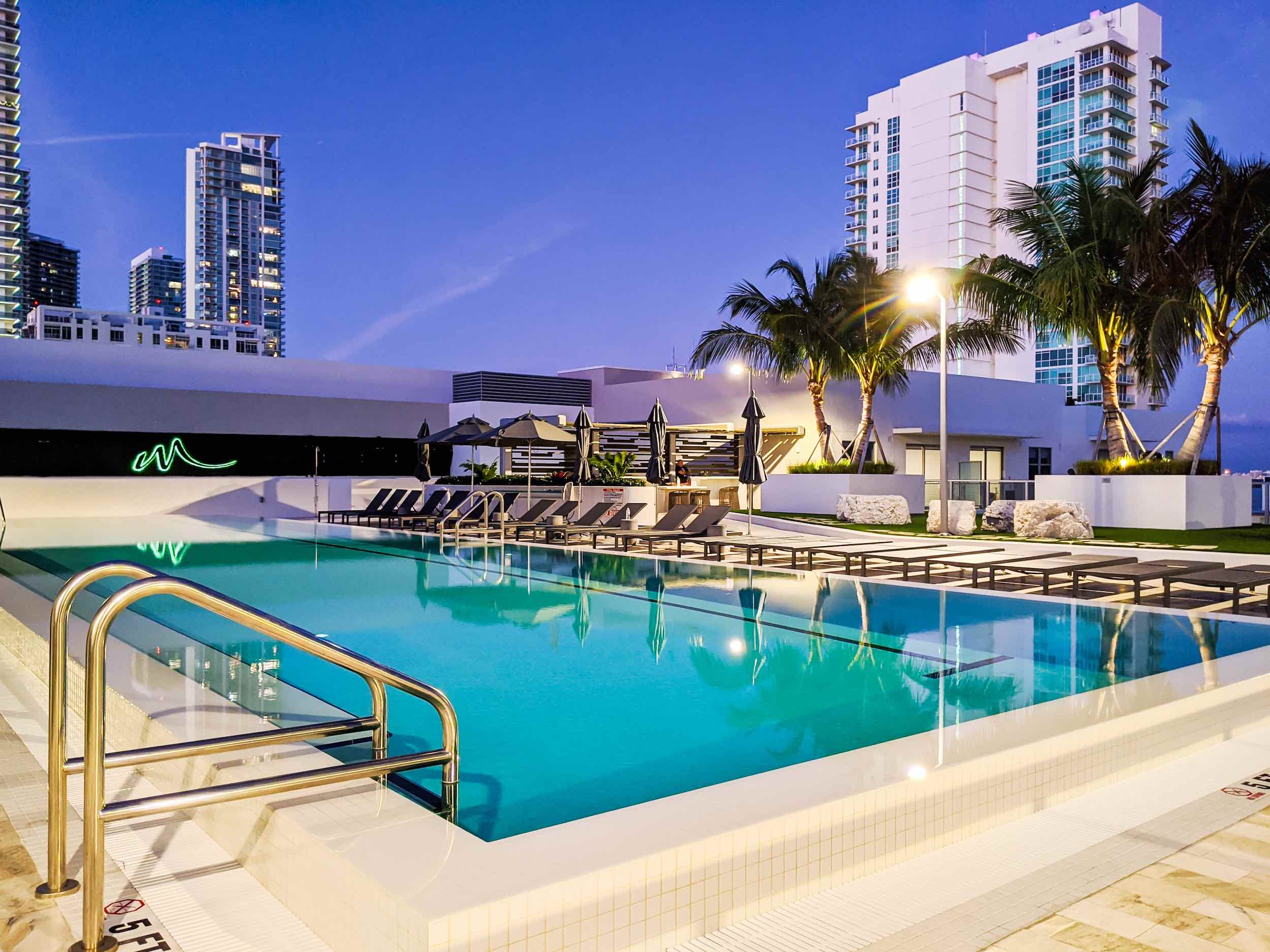 Rooftop pool, palms and outdoor gathering areas at Modera Edgewater