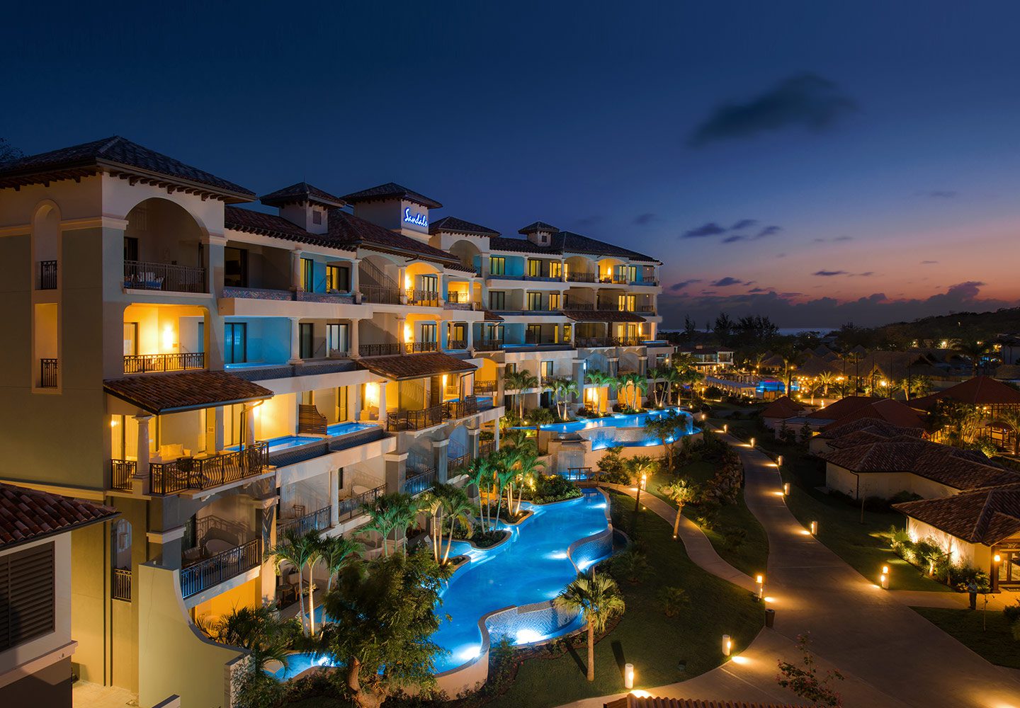 Illuminated pools and planted pathways at Sandals LaSource Grenada Resort & Spa